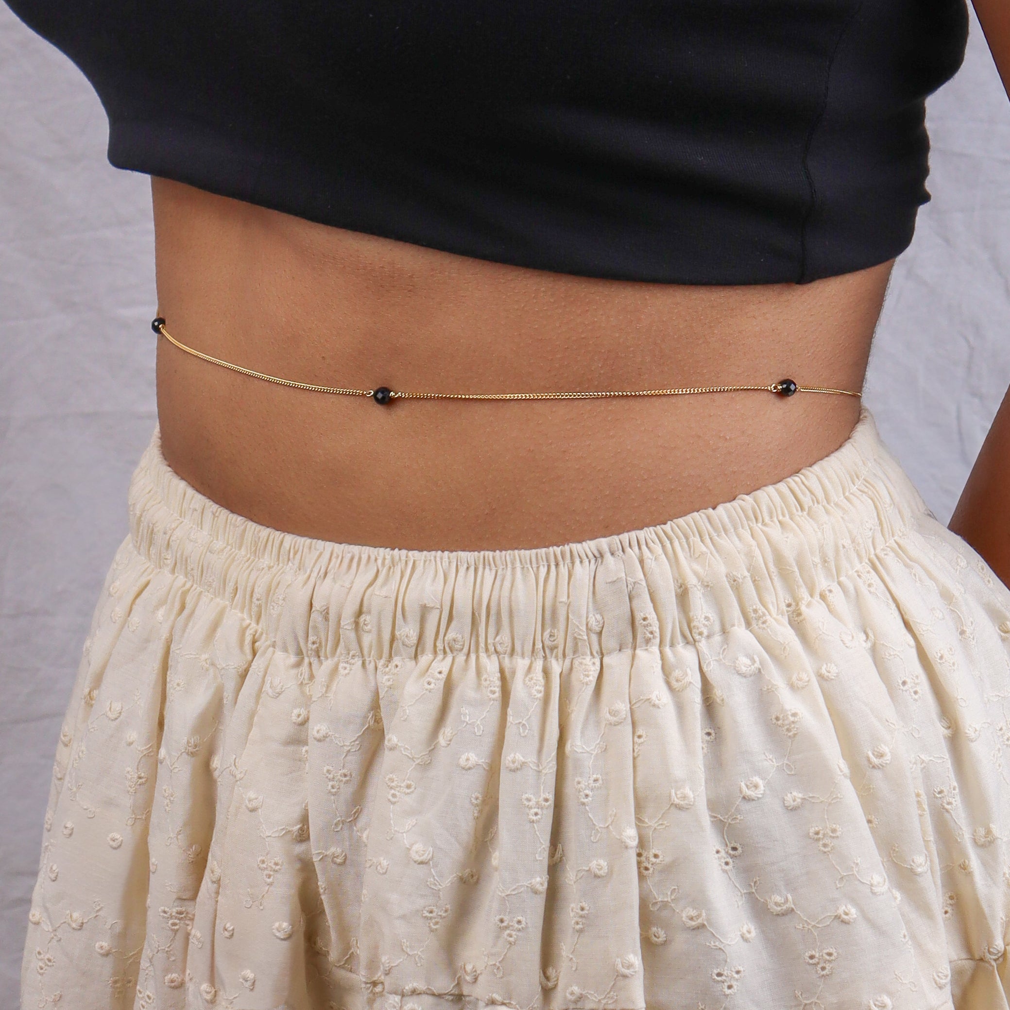Gold chain with black beads