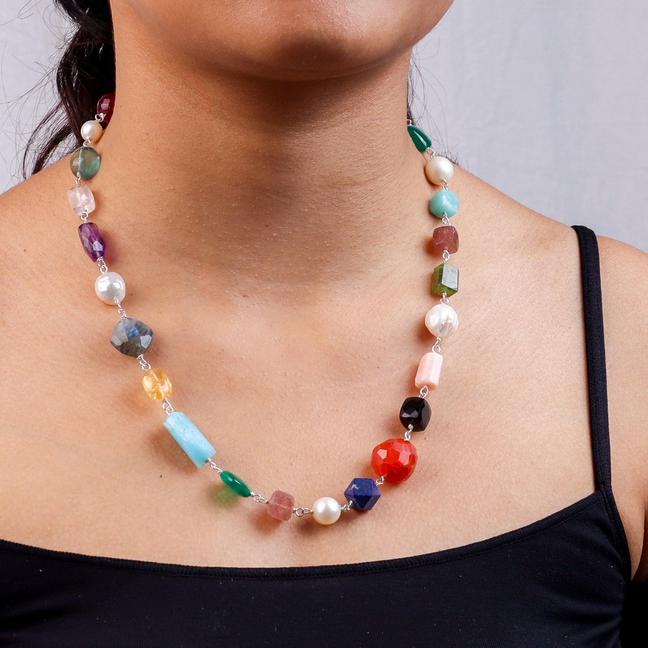 Close-up of multicolour stone necklace on model