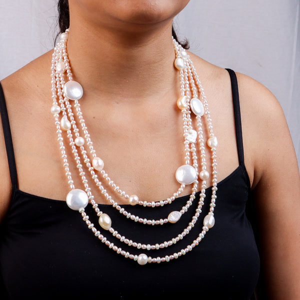 Close-up of layered pearl necklace on model
