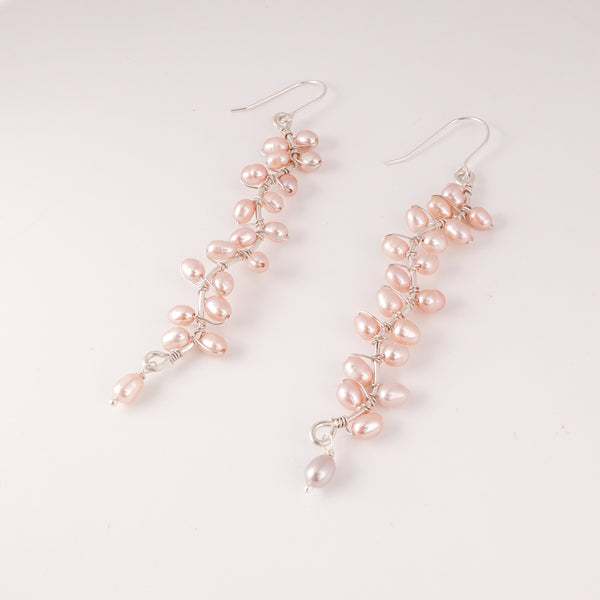 Model wearing Heliconia Pearl Flower Earrings for elegant festive and occasion styling