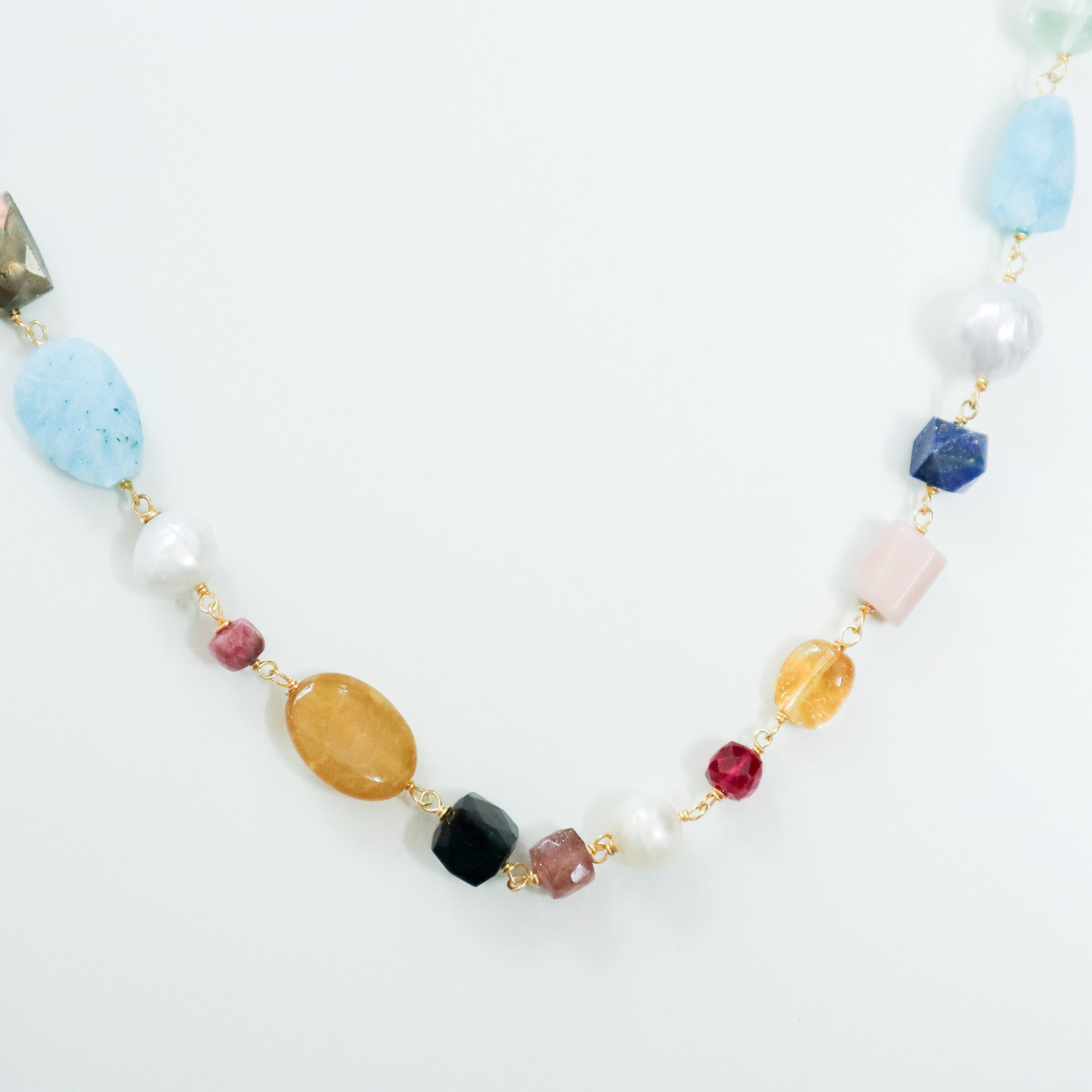 Colorful gemstone necklace with gold chain close-up