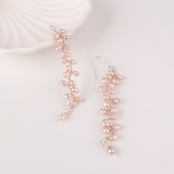 Woman styling Heliconia pearl flower earrings with ethnic outfit for wedding look