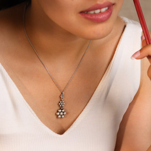 Sterling silver Kudi pendant necklace on woman