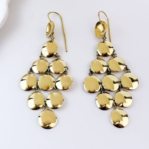 Close-up of brass fashion earrings showcasing intricate detailing, textured elements, and fine craftsmanship