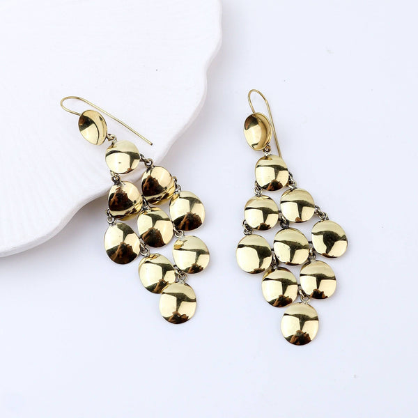 Angled view of brass fashion earrings highlighting the unique silhouette, structure, and polished brass finish
