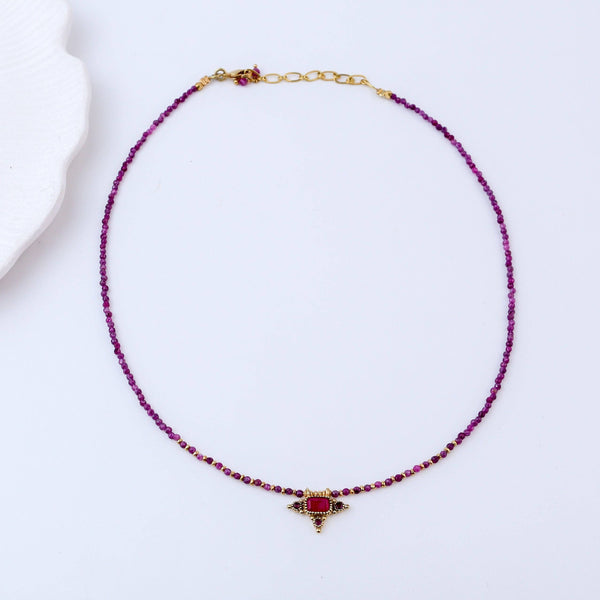 Detailed view of a brass fashion necklace highlighting intricate motifs, textured surface, and refined brass finish
