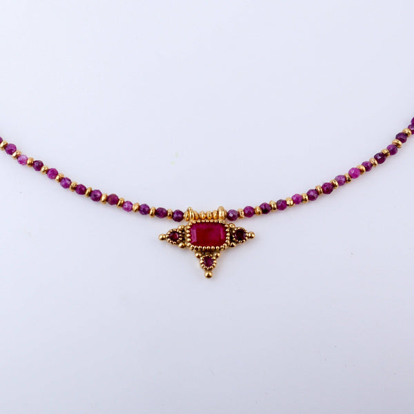 Close-up of a brass fashion necklace showcasing intricate detailing, textured elements, and fine craftsmanship