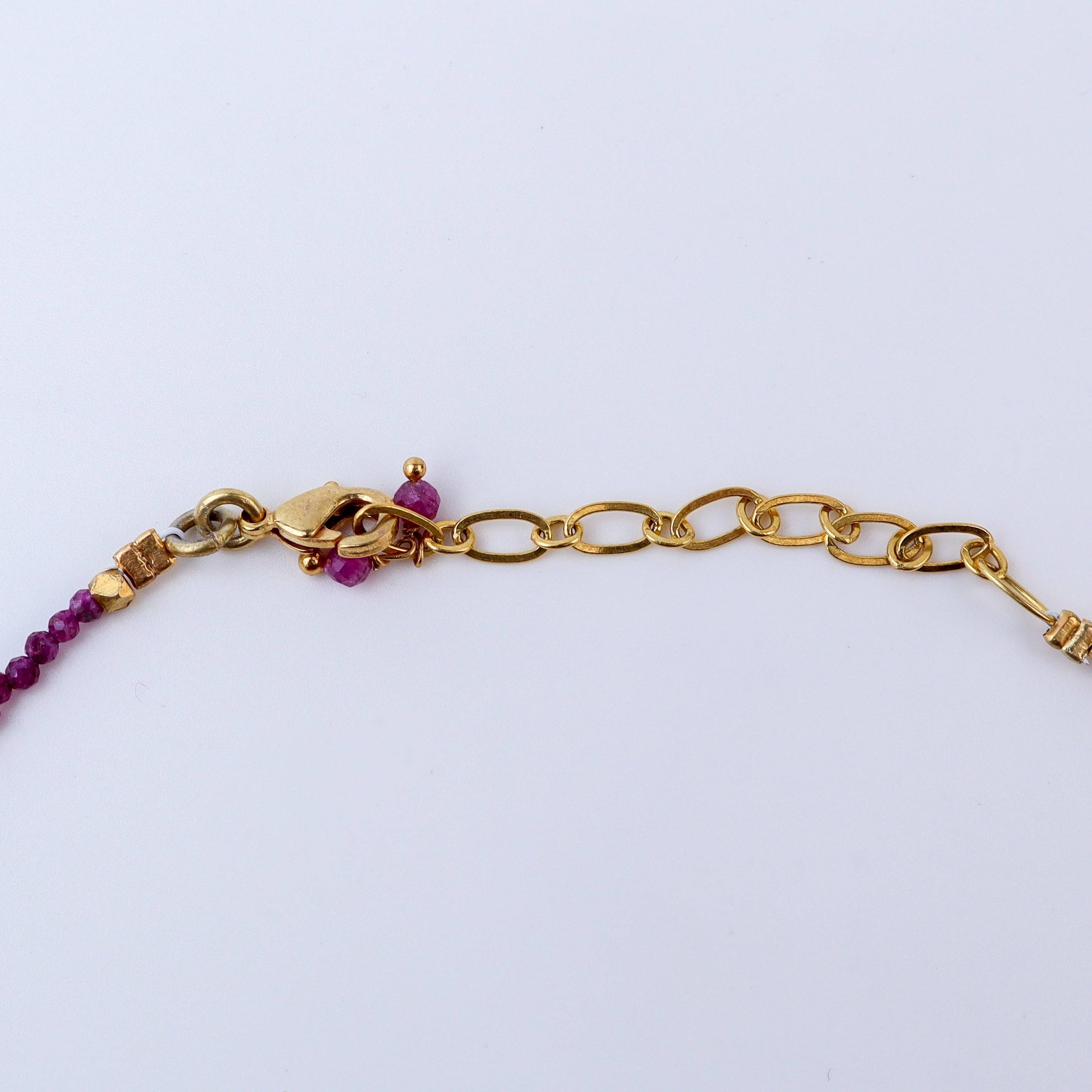 Angled view of a brass fashion necklace highlighting its unique silhouette, structure, and polished brass finish
