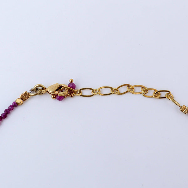 Angled view of a brass fashion necklace highlighting its unique silhouette, structure, and polished brass finish