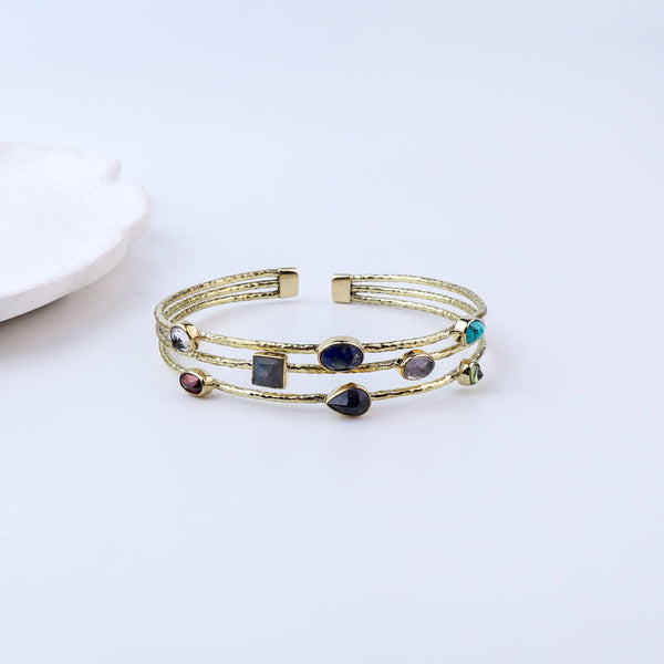 Close-up of a brass fashion bracelet showcasing intricate detailing, textured elements, and fine craftsmanship