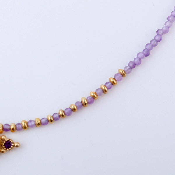 Close-up of a brass fashion necklace showcasing intricate detailing, textured elements, and fine craftsmanship