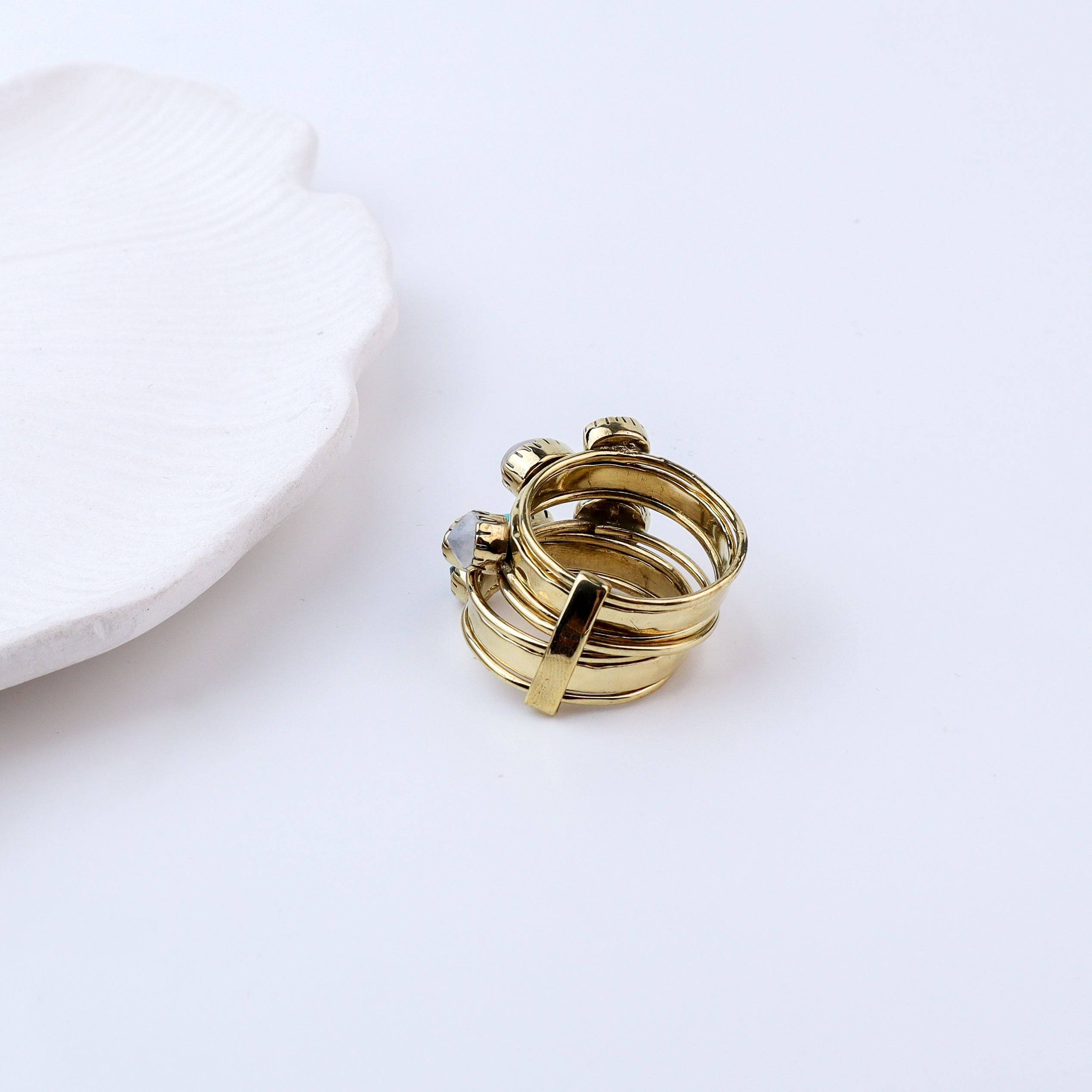 Flat-lay of Brass Fashion Ring with complementary jewellery and accessories for a chic styling setup