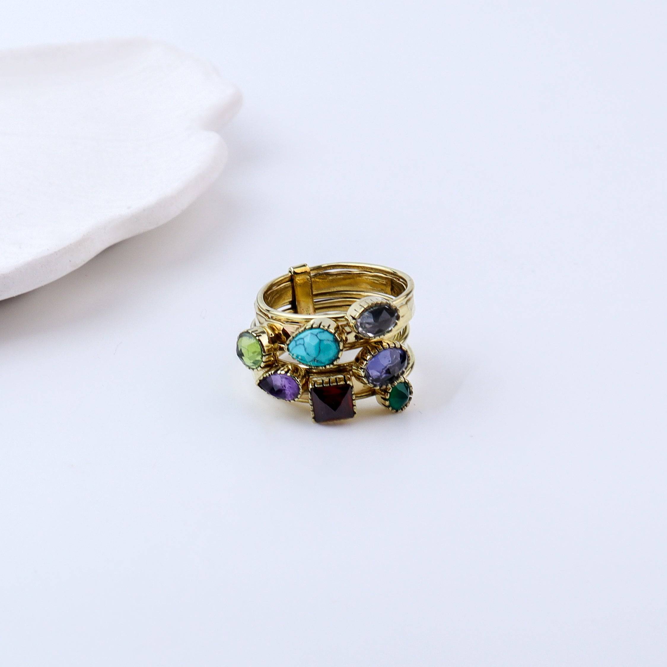 Flat-lay of a brass fashion ring with complementary jewellery and accessories for a chic styling setup