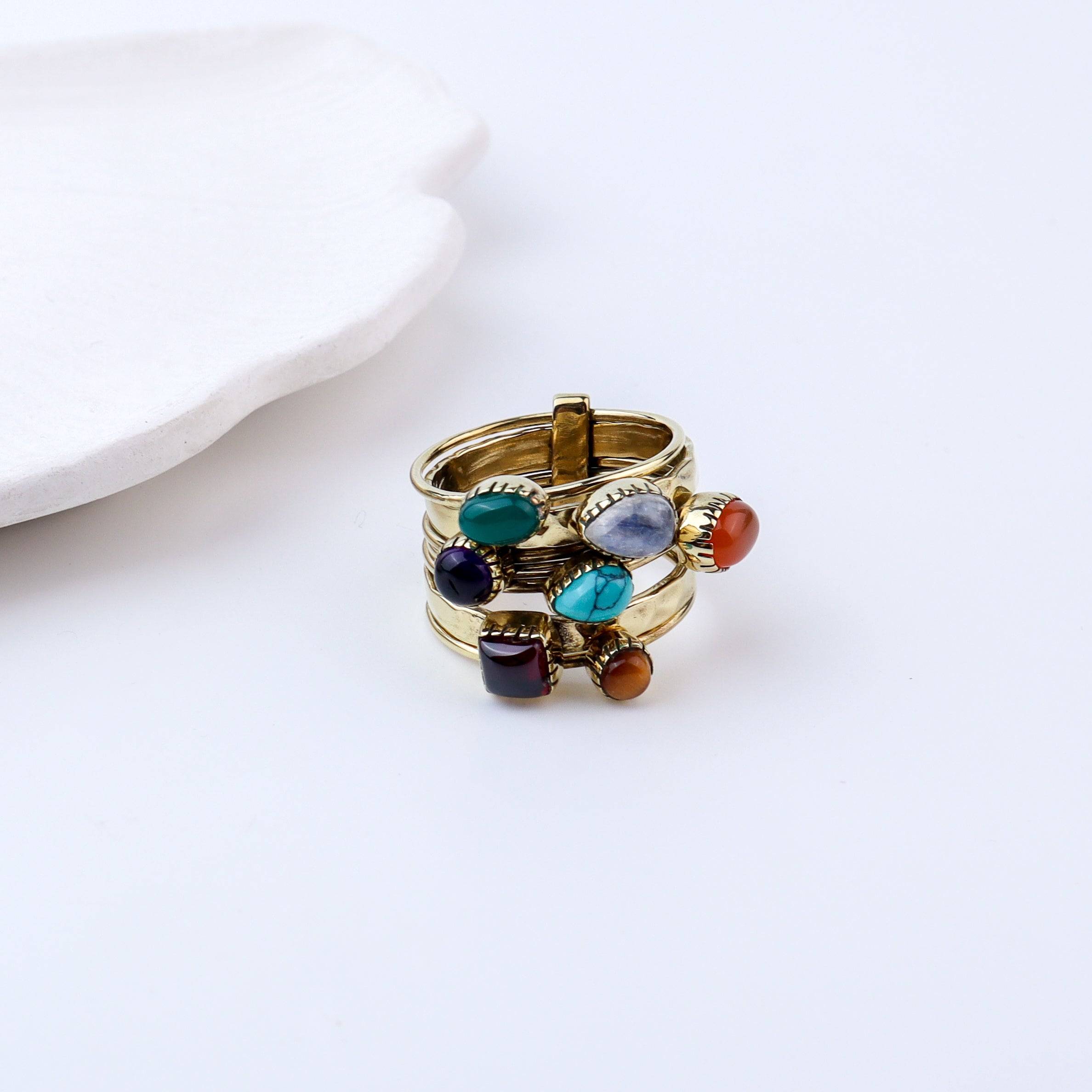 Flat-lay of a brass fashion ring with complementary jewellery and accessories for a chic styling setup
