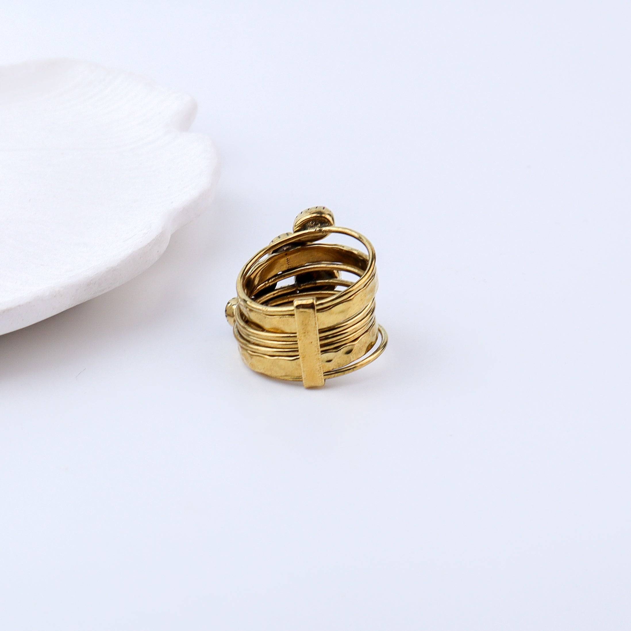 Flat-lay of Brass Fashion Ring with complementary jewellery and accessories for a chic styling setup
