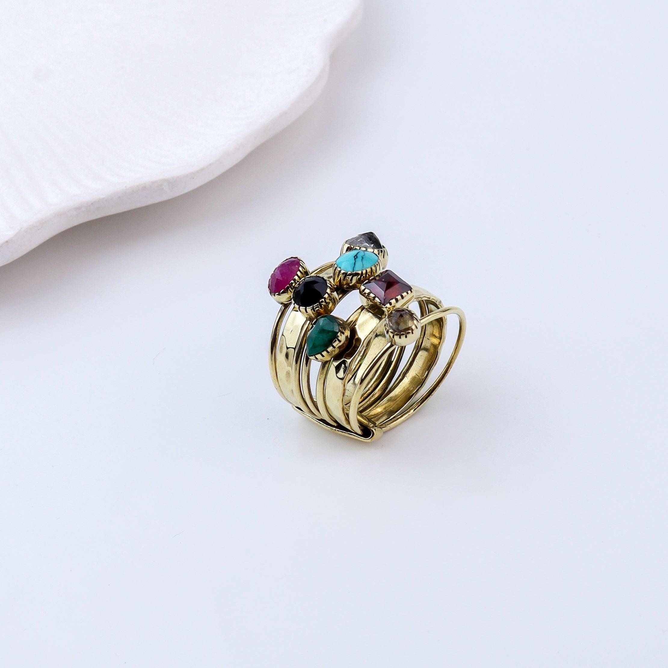 Flat-lay of a brass fashion ring with complementary jewellery and accessories for a chic styling setup