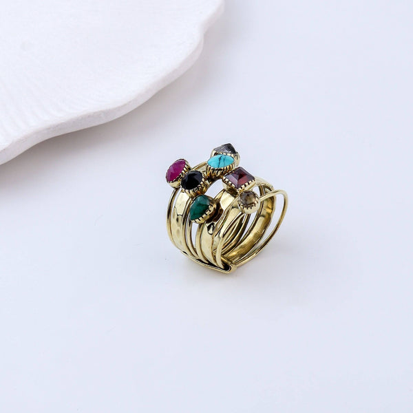 Flat-lay of a brass fashion ring with complementary jewellery and accessories for a chic styling setup