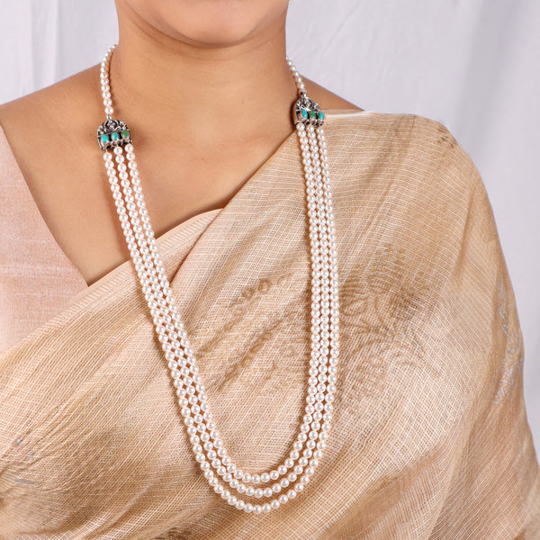 Elegant pearl necklace with carved findings and green semi-precious stones