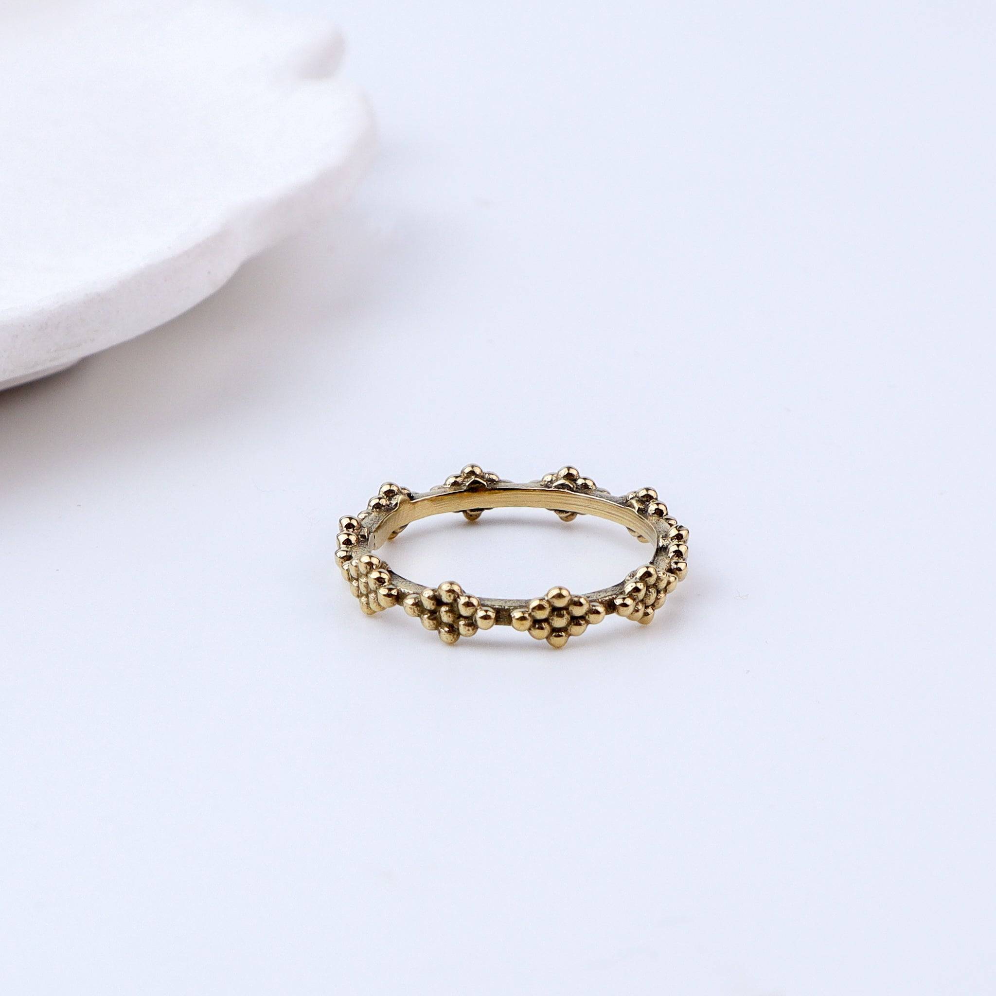 Flat-lay of Brass Fashion Ring with complementary jewellery and accessories for a chic styling setup