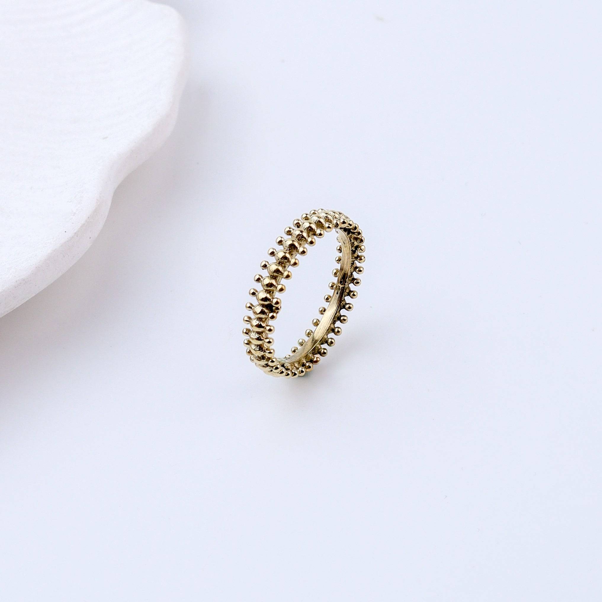 Flat-lay of Brass Fashion Ring with complementary jewellery and accessories for a chic styling setup