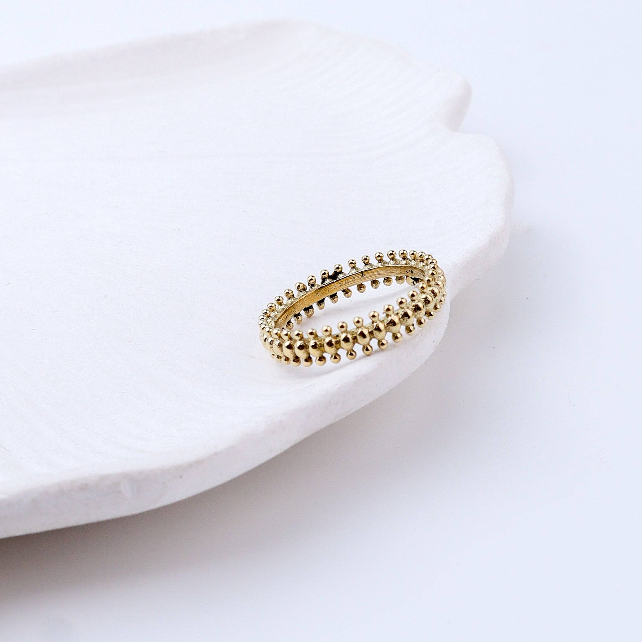 Angled view of Brass Fashion Ring highlighting its distinctive shape and polished brass finish