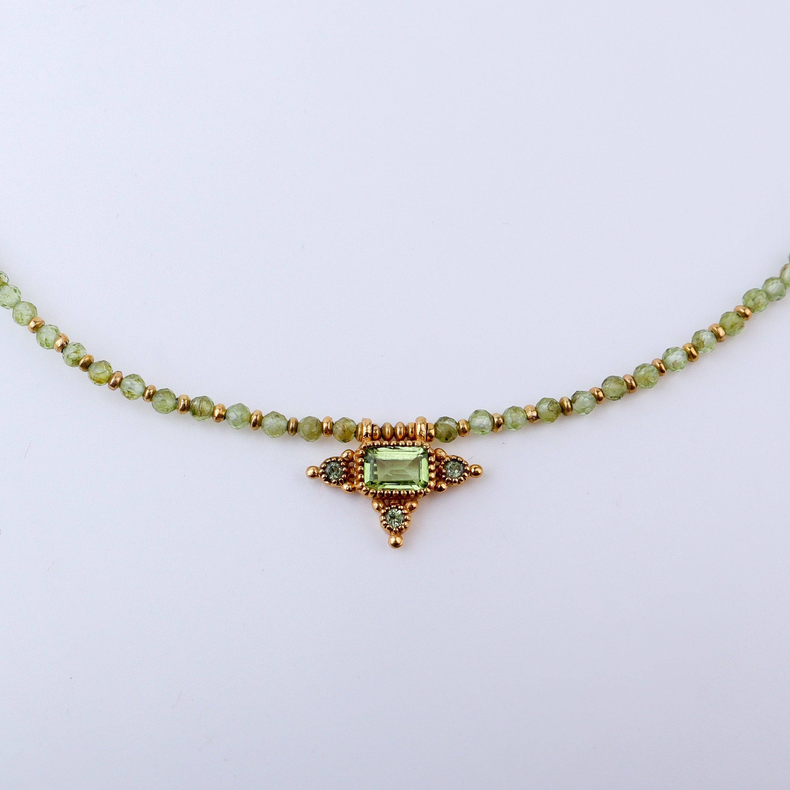 Close-up of a brass fashion necklace showcasing intricate detailing, textured elements, and fine craftsmanship