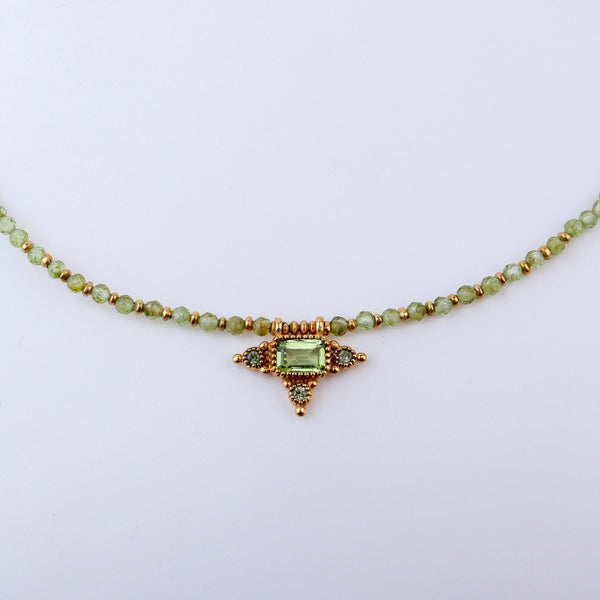 Close-up of a brass fashion necklace showcasing intricate detailing, textured elements, and fine craftsmanship