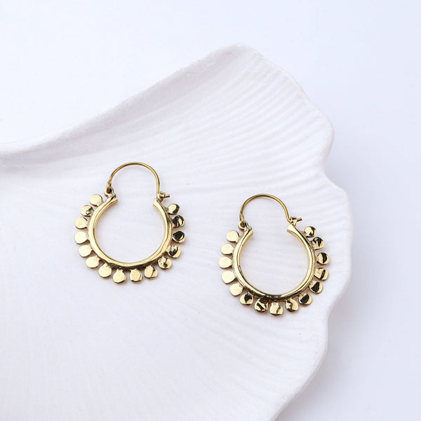 Angled view of Brass Fashion Earrings highlighting the unique silhouette, structure, and polished brass finish