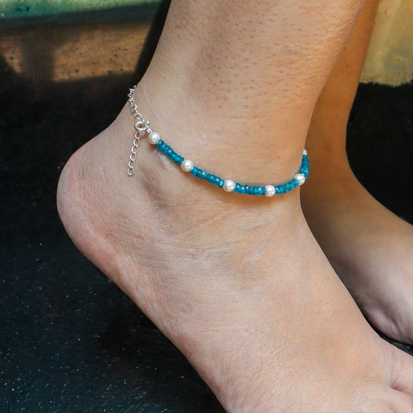 Close-up of blue beaded anklet on ankle