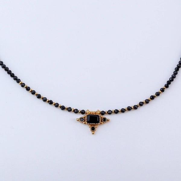Close-up of a brass fashion necklace showcasing intricate detailing, textured elements, and fine craftsmanship