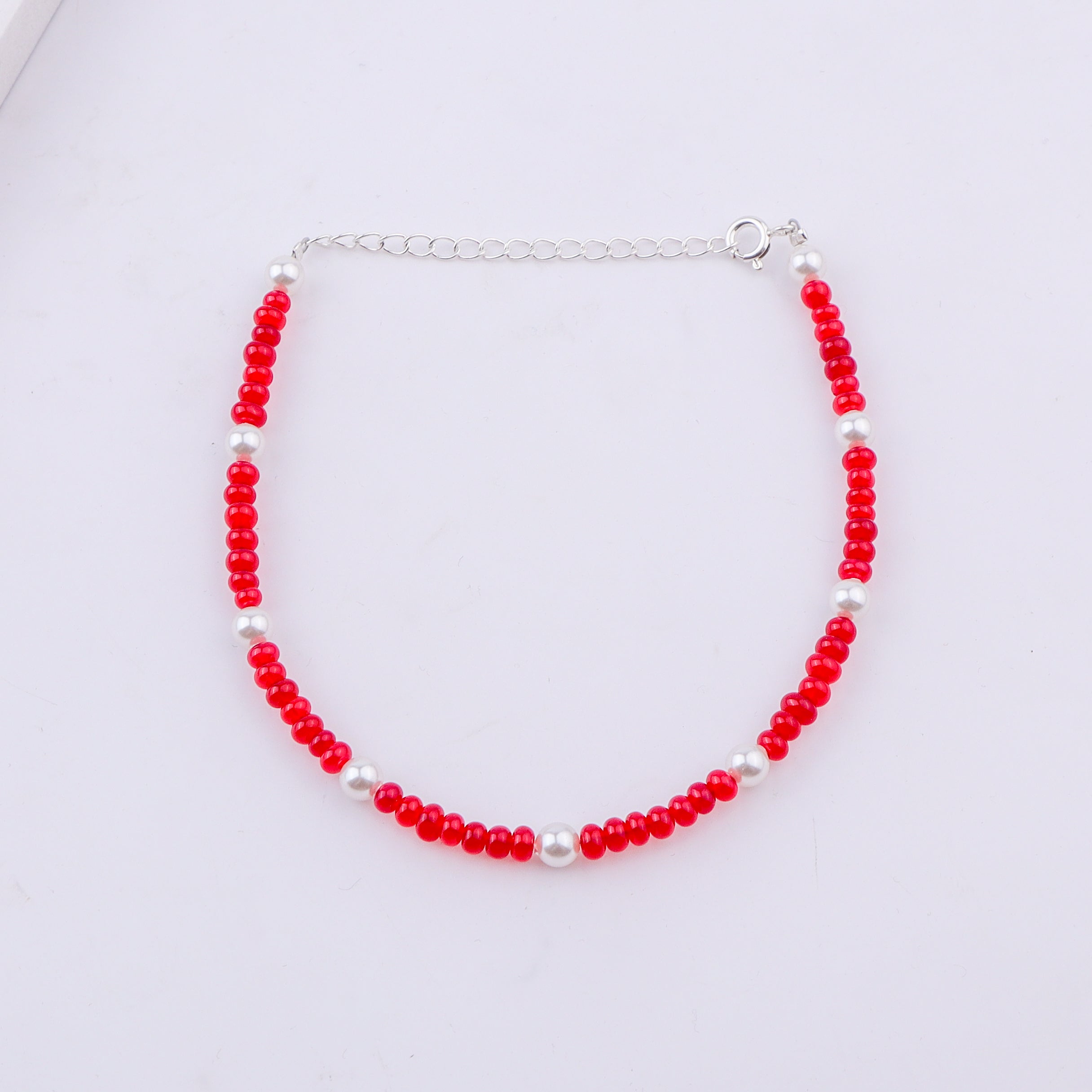 Red and white beaded anklet with silver clasp
