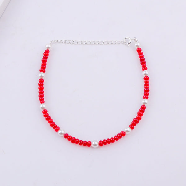 Red and white beaded anklet with silver clasp