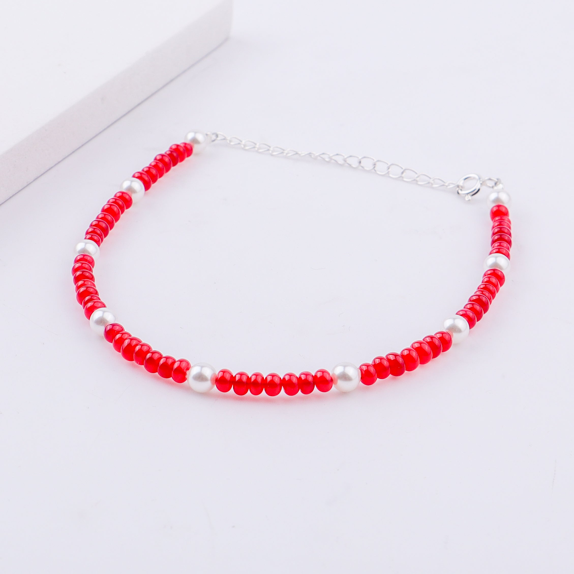 Red and white beaded anklet with silver chain extension