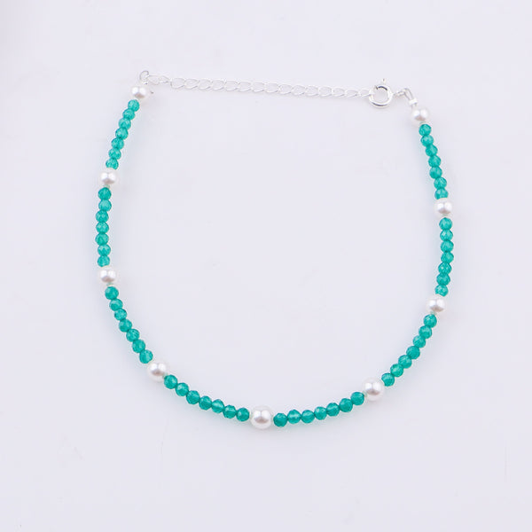 Silver chain with turquoise beads and pearls on white background