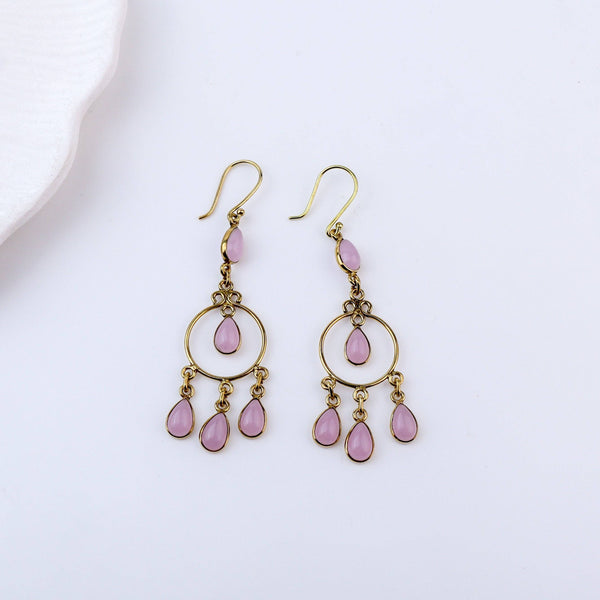 Detailed view of brass fashion earrings highlighting intricate motifs, textured surface, and refined brass finish