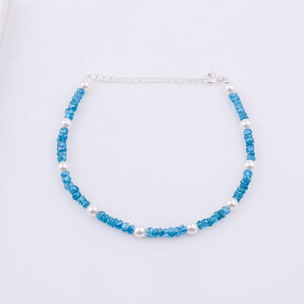 Blue beaded anklet with pearls on white background