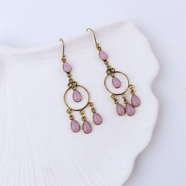 Angled view of brass fashion earrings highlighting the unique silhouette, structure, and polished brass finish