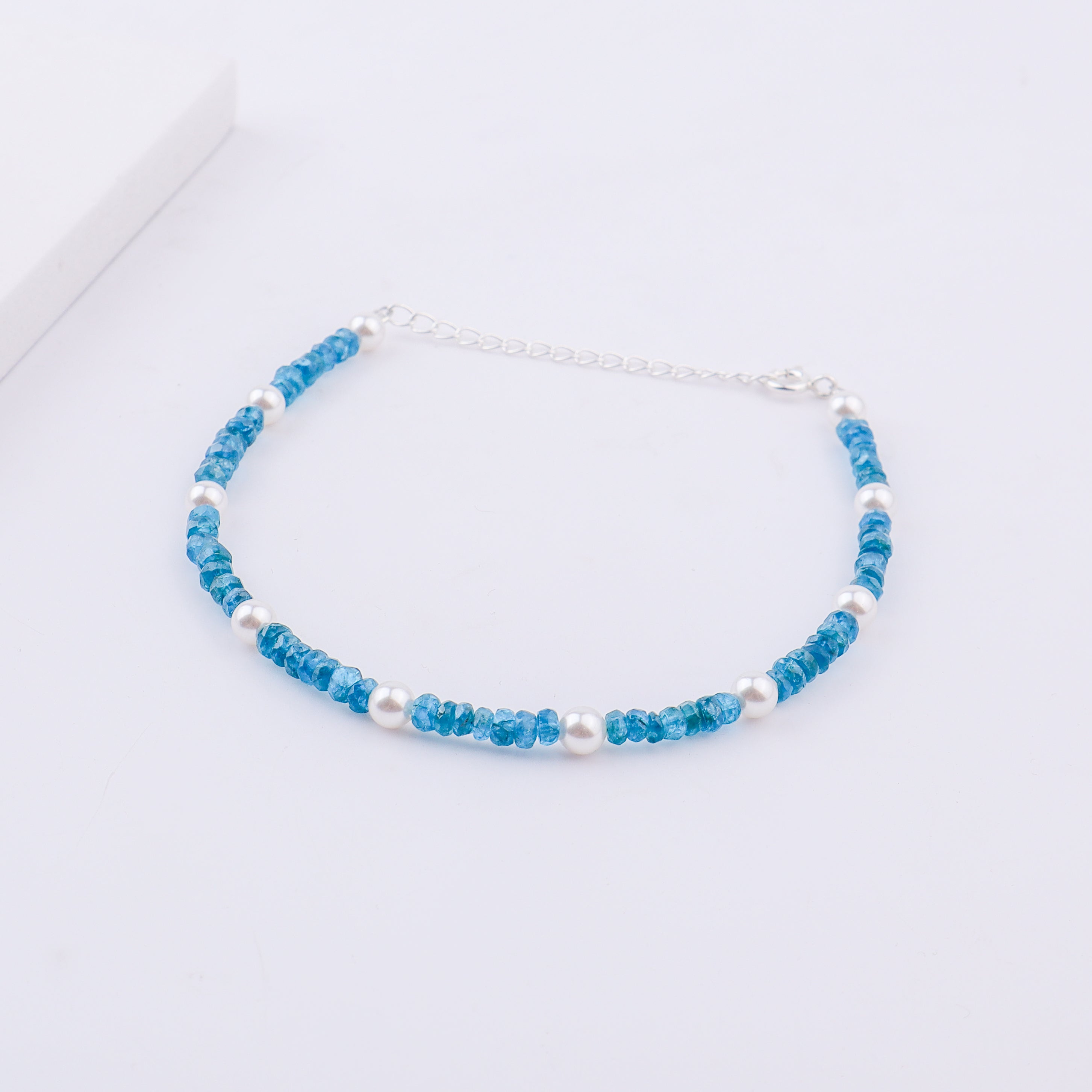 Silver chain extension of anklet with blue beads and pearls