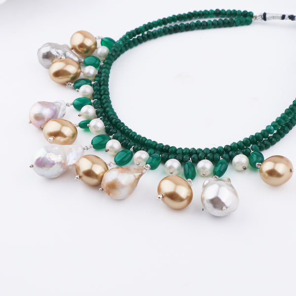 Close-up of green onyx, pearls, and baroque pearls on the necklace