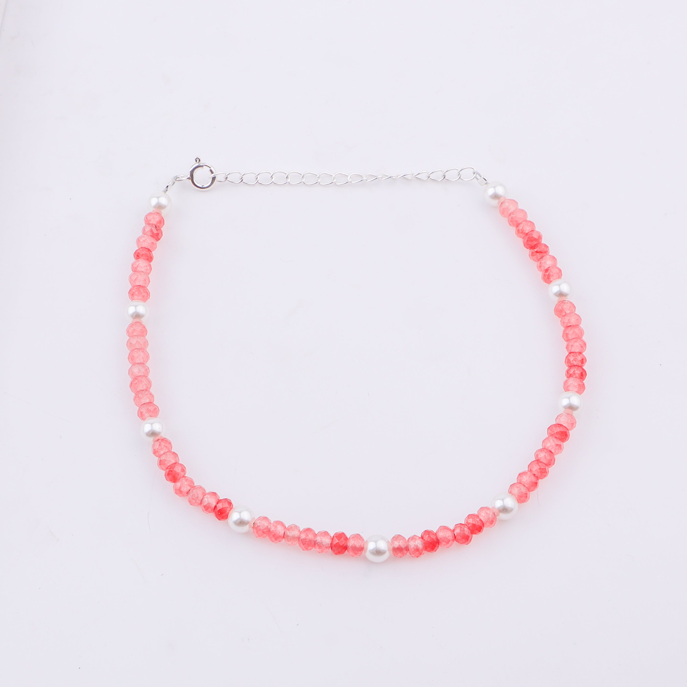Pink beaded anklet with white pearls and silver chain on ankle