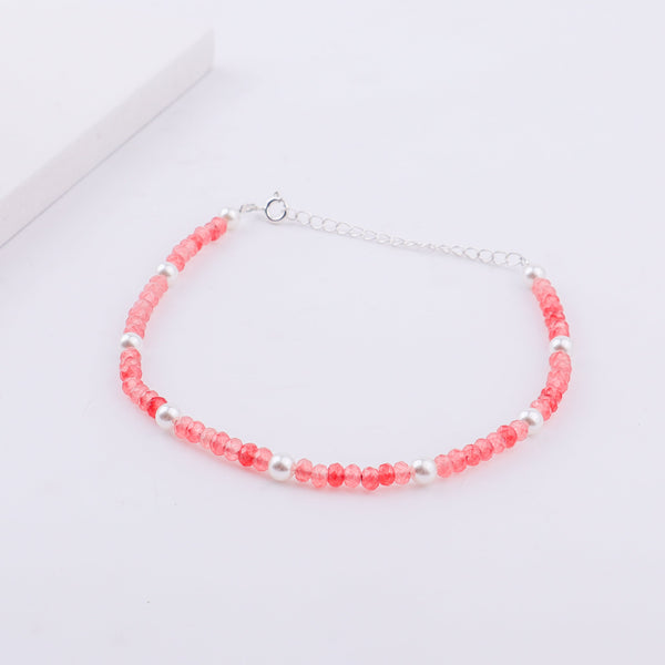 Pink beaded anklet with white pearls and silver chain on ankle