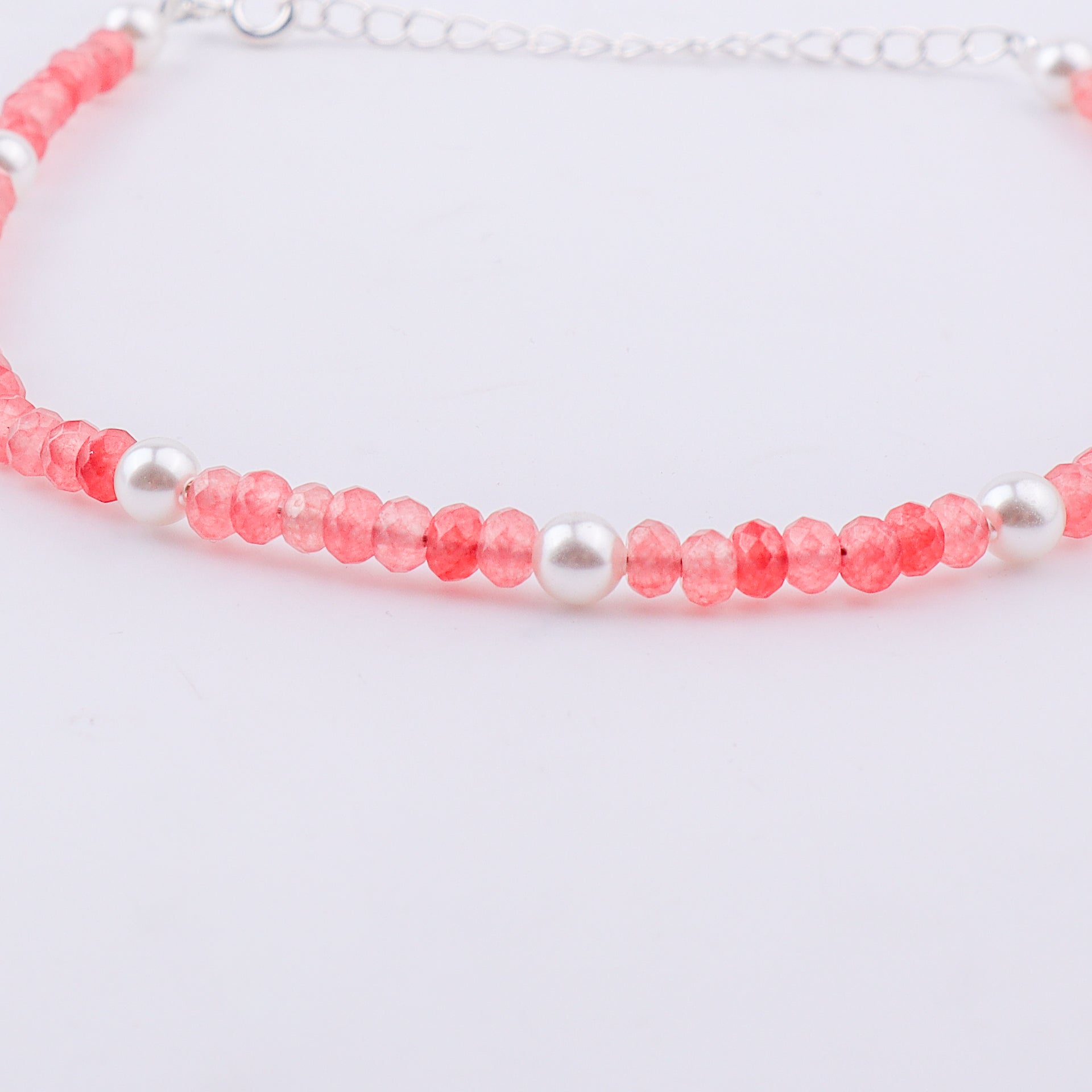 Pink beaded anklet with white pearls and silver chain on ankle