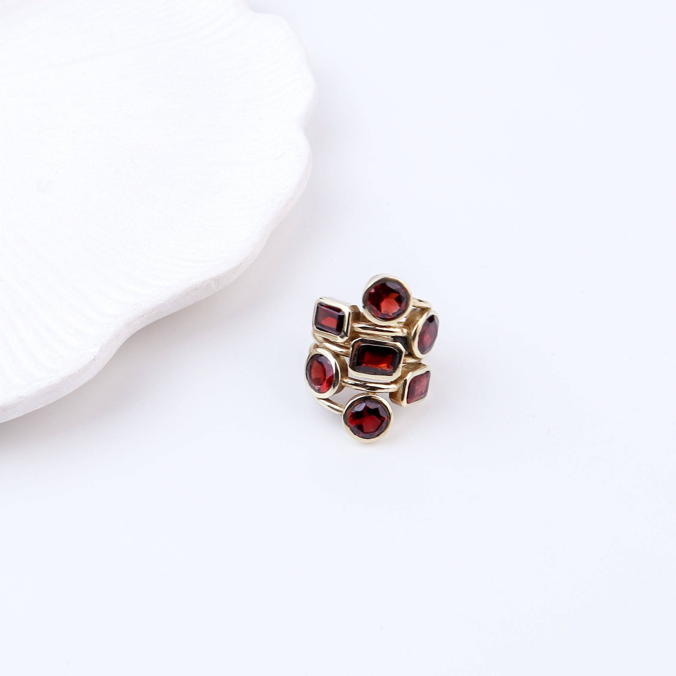 Flat-lay of a brass fashion ring with complementary jewellery and accessories for a chic styling setup