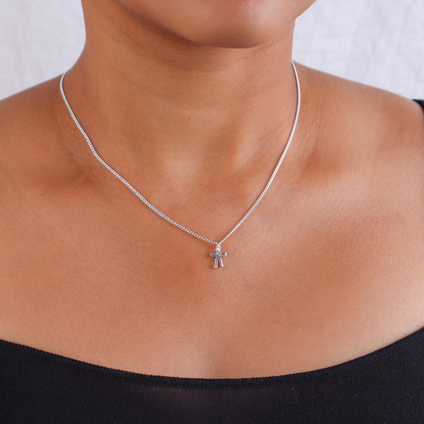 Silver bow pendant necklace on a person's neck