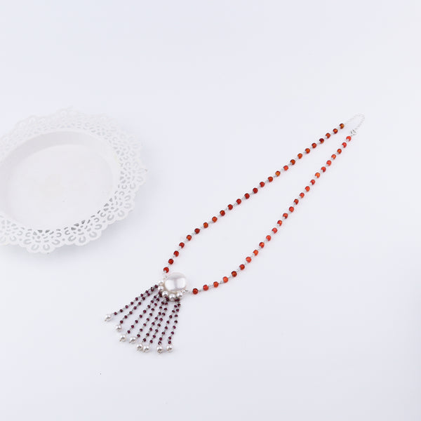 Woman styling Luxe Necklace with pearls and statement outfit