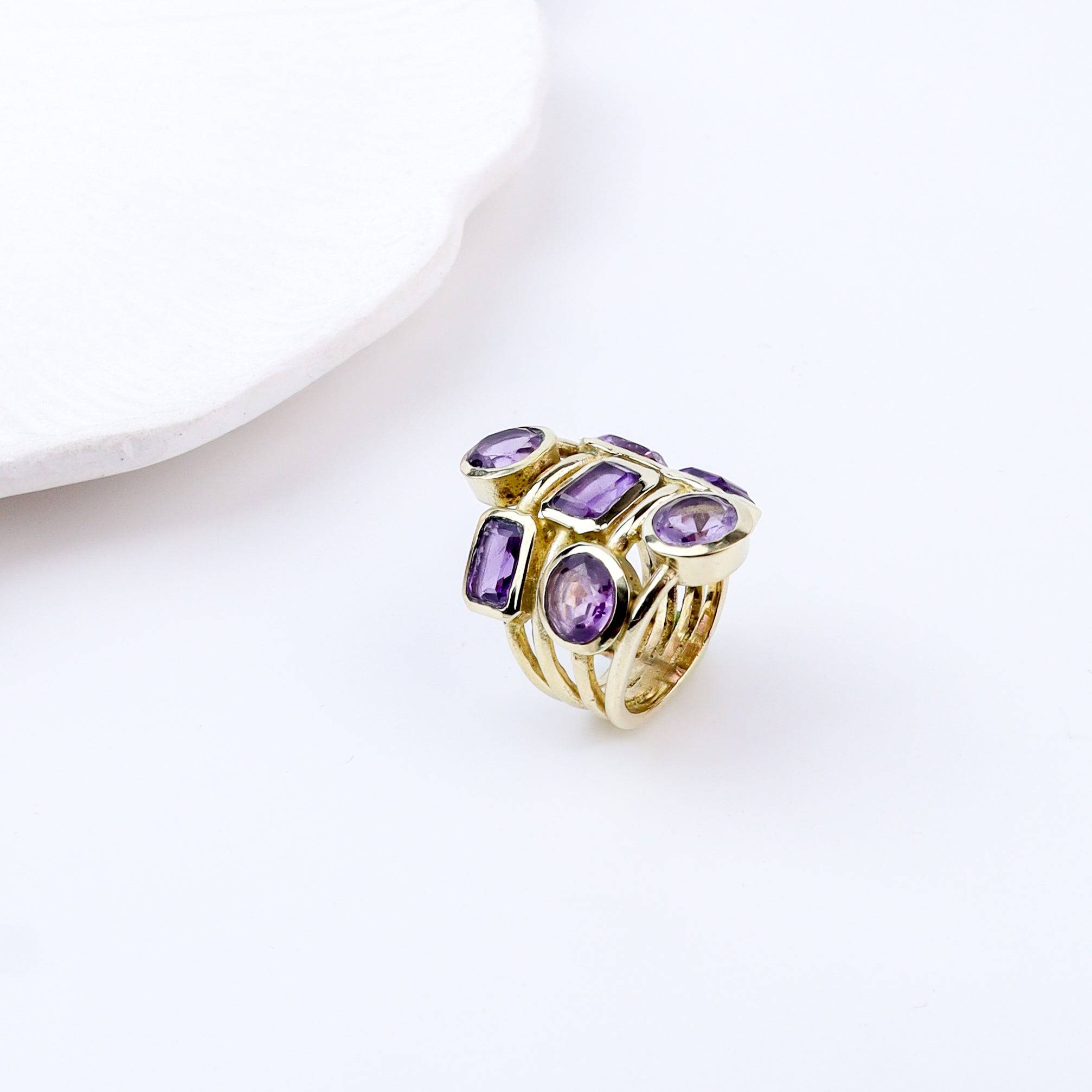 Close-up of a brass fashion ring showcasing intricate detailing, unique design, and fine craftsmanship
