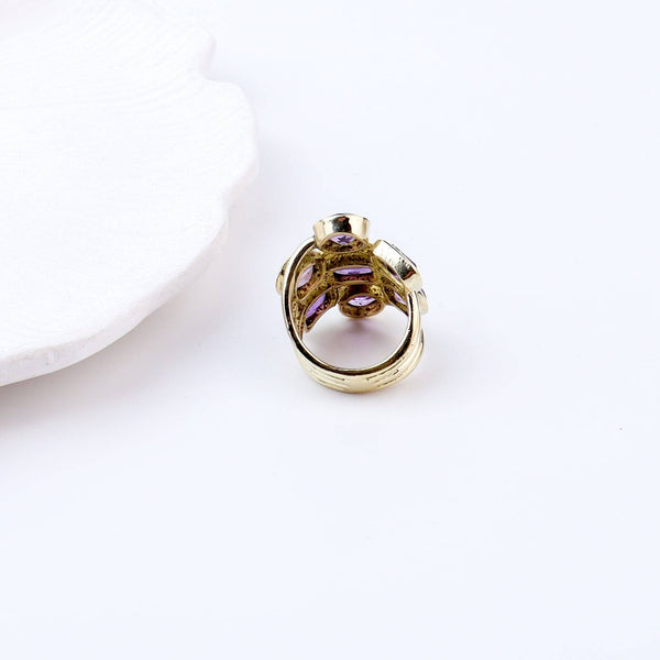 Flat-lay of a brass fashion ring with complementary jewellery and accessories for a chic styling setup