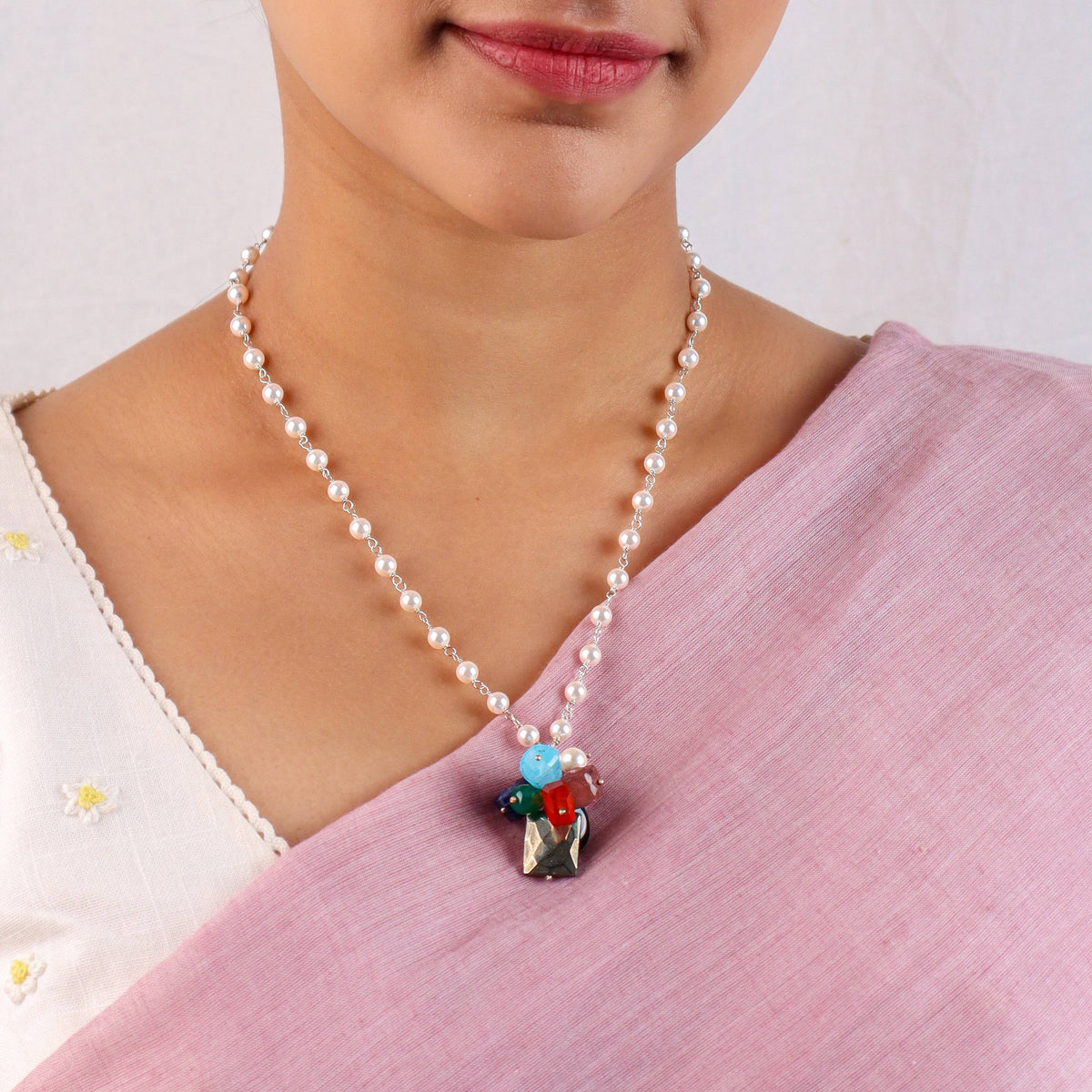 Close-up of multicolour stone bunch necklace highlighting clustered stones and lustrous pearl Gantan detailing