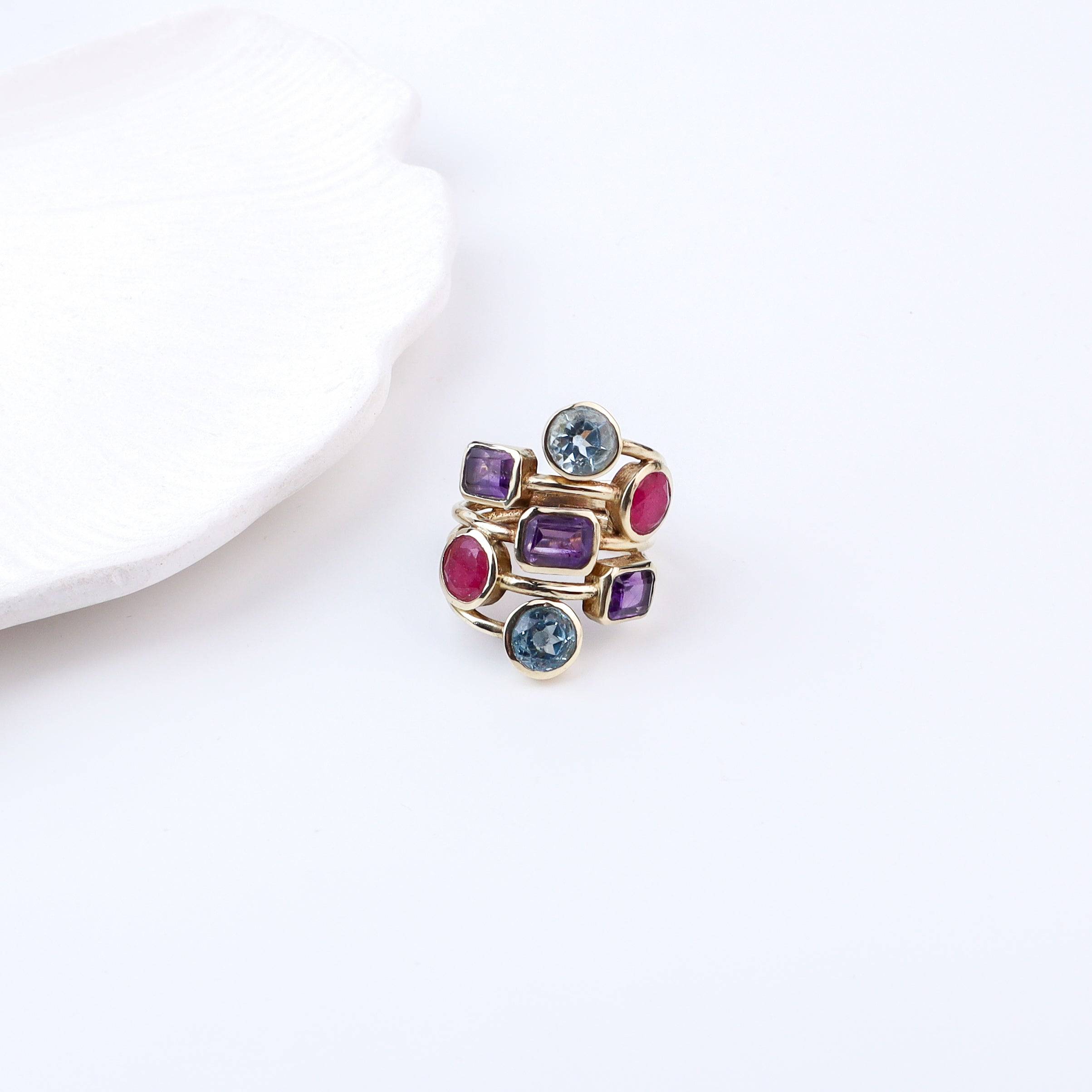 Flat-lay of a brass fashion ring with complementary jewellery and accessories for a chic styling setup