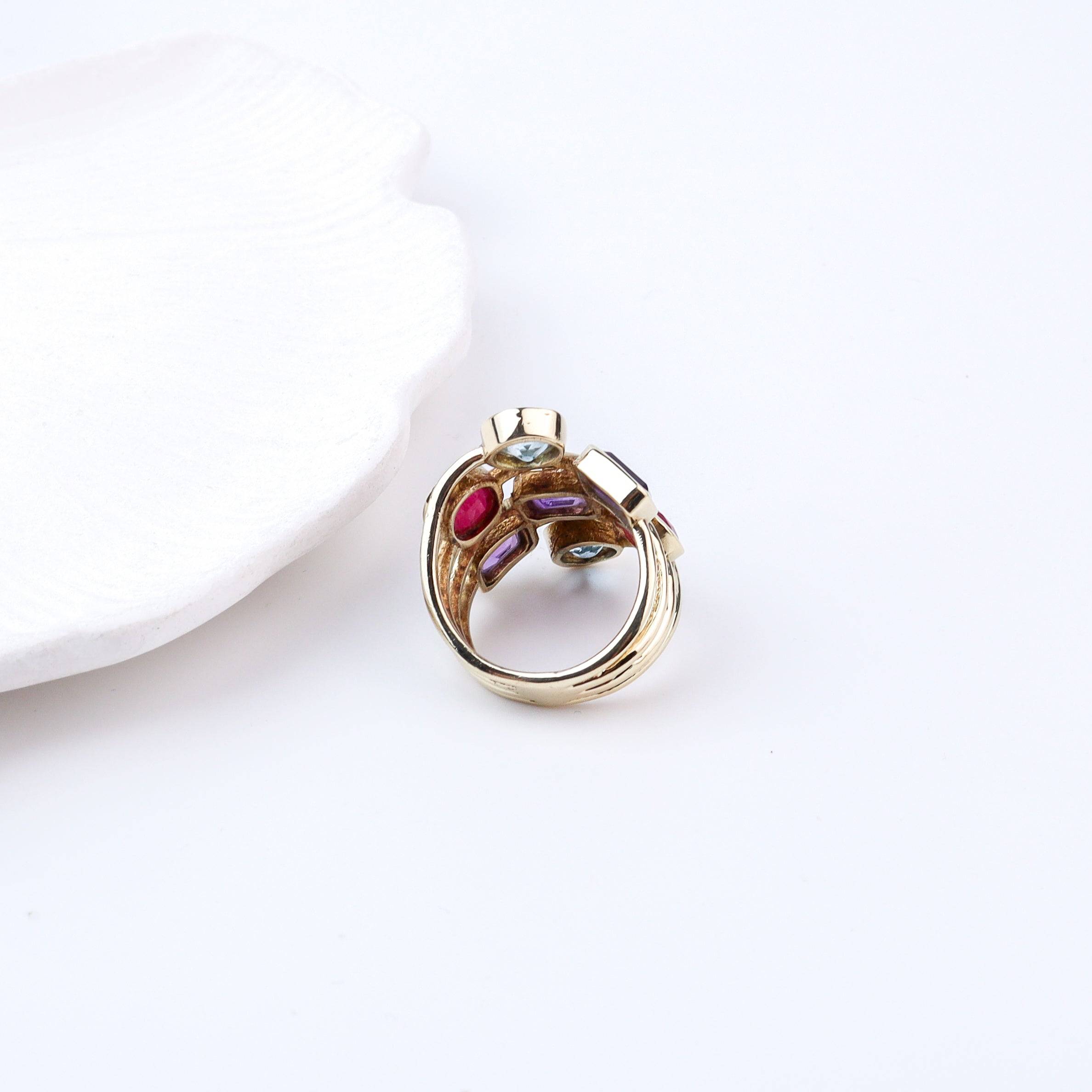 Angled view of a brass fashion ring highlighting its distinctive shape, structure, and polished brass finish